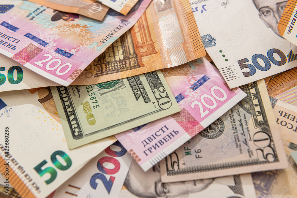 Money background from different countries dollars euro and hryvnia banknotes Money background from different countries dollars euro and hryvnia banknotes