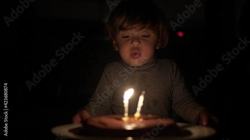 Wallpaper Mural Baby toddler celebrating birthday, child blowing cake candles in slow-motion Torontodigital.ca