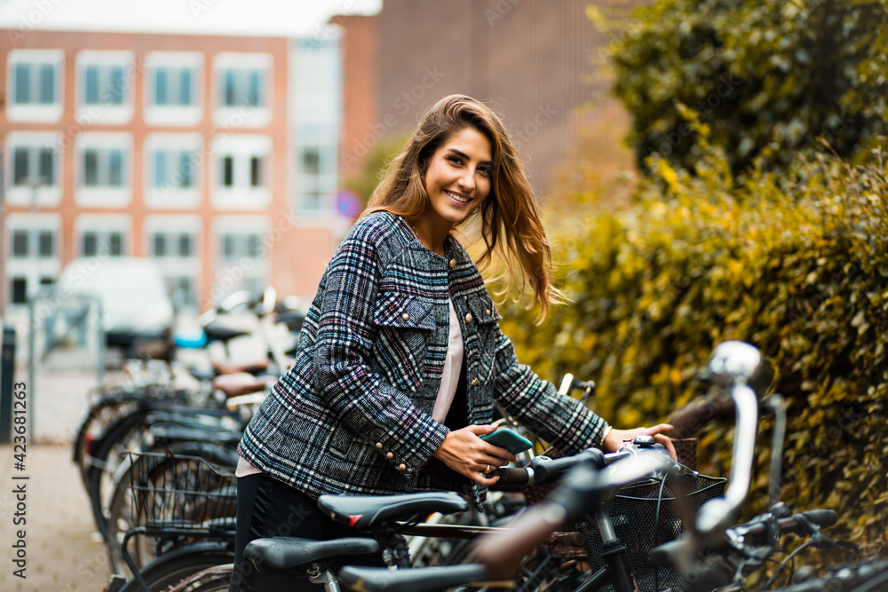 Woman on street with bike.