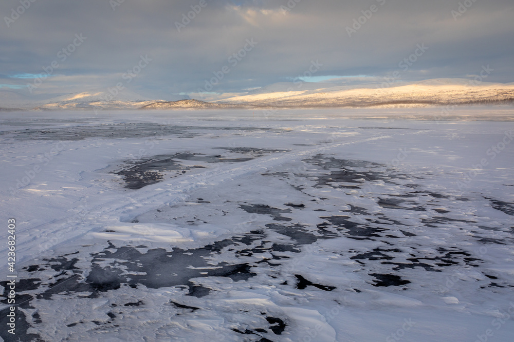 The frozen lake Torneträsk in Swedish Lapland. Beautiful ice forms create an amazing sight. The frozen lake Torneträsk in Swedish Lapland. Beautiful ice forms create an amazing sight.