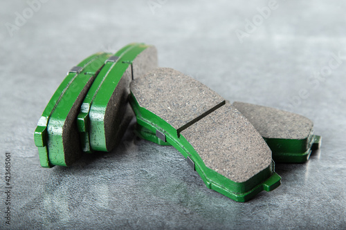 a set of new green brake pads on a gray table photo