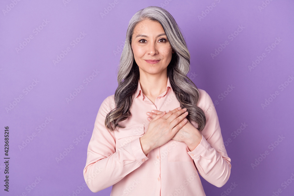 Portrait of attractive cheery honest affectionate woman touching heart praying isolated over violet purple color background - obrazy, fototapety, plakaty 