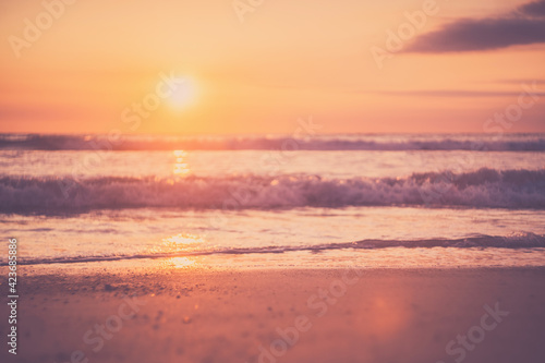 Tropical beach with smooth wave and sunset sky abstract background. © tonktiti