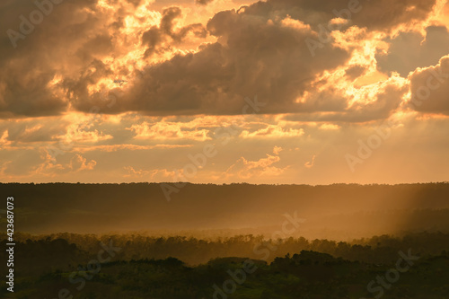 orange twilight sunset sky over green mountains scene