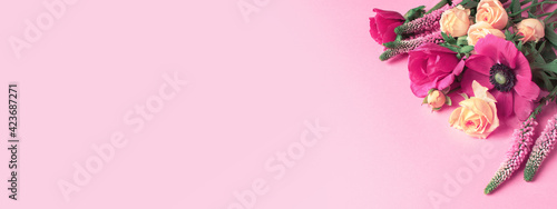 Fresh multicolor summer flowers on the pink background, vibrant bouquet