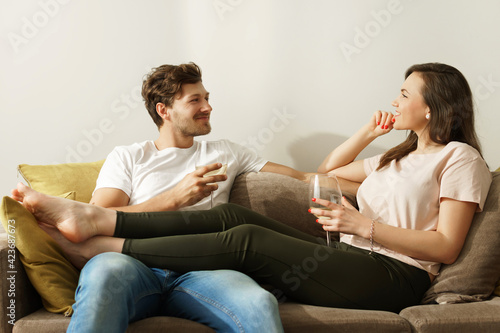 Happy couple drinking wine and relaxing at home