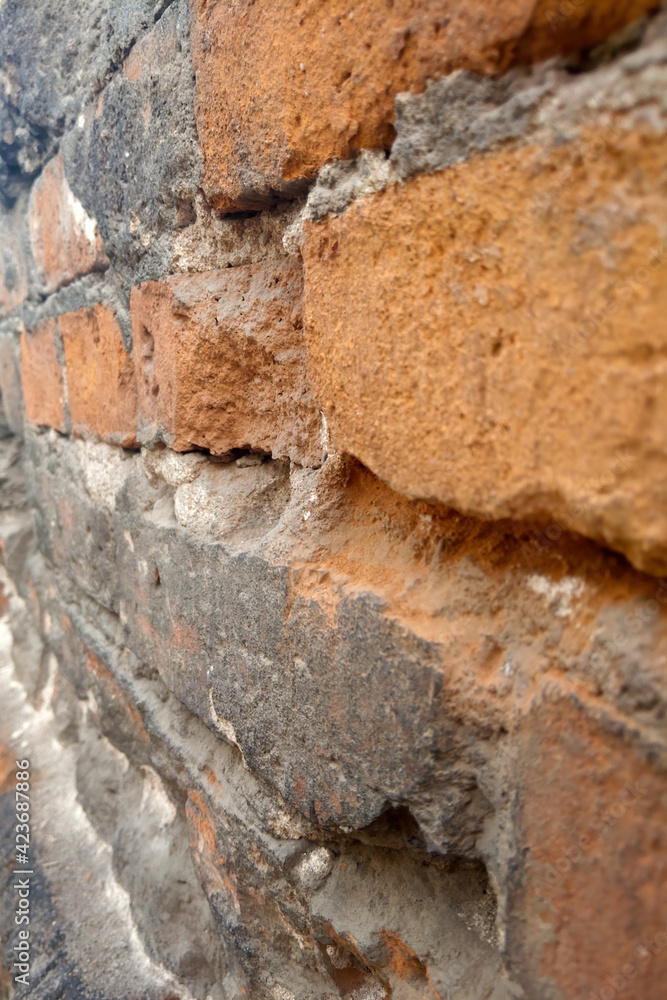 Vertical photo. Red brick building wall texture.