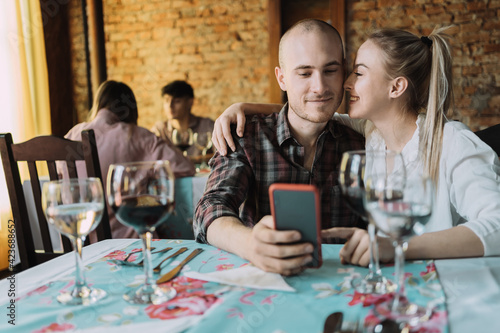 Caucasian couple enjoying their date in a restaurant.