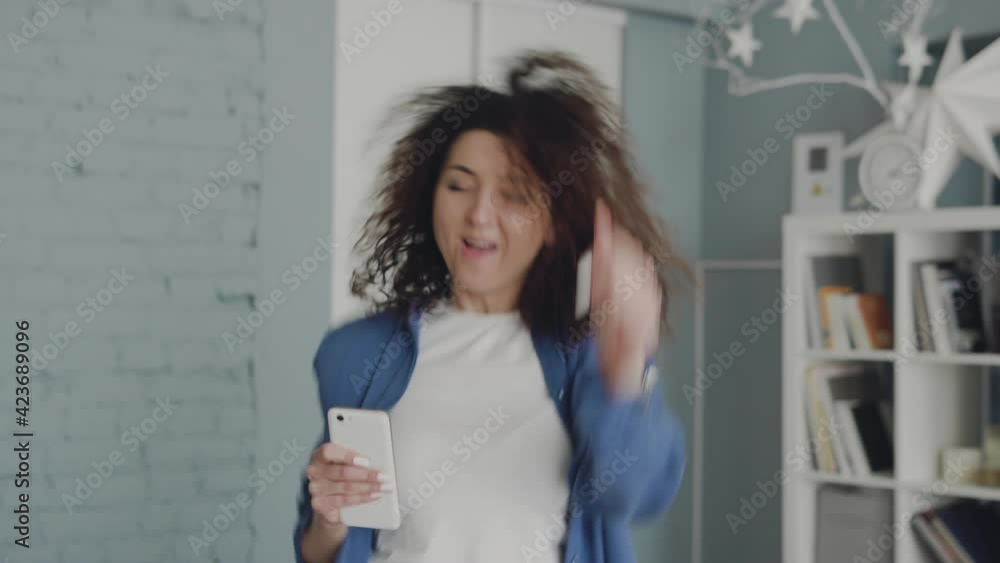 Cheerful positive woman singing song and happily dancing, enjoying life, has fun Cheerful positive woman singing song and happily dancing, enjoying life, has fun