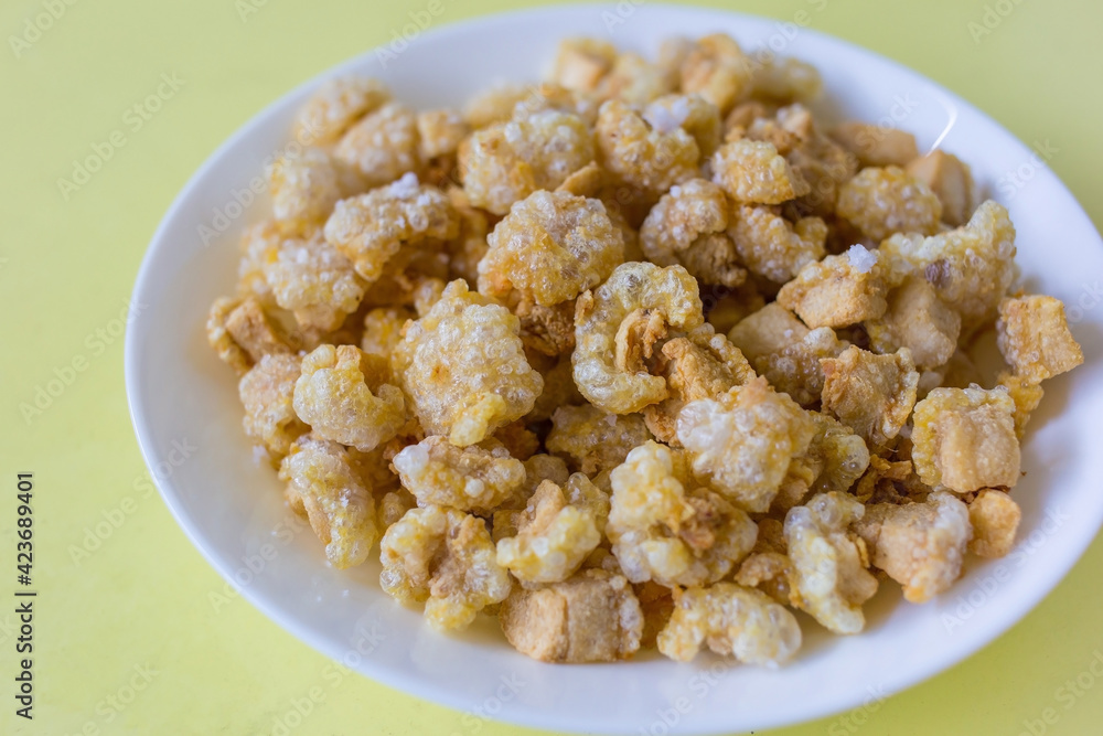 Pork crackling (pork snack, pork scratching) is fried pork skin as snack and we can eat it with noodles in Thai food style. Pork crackling (pork snack, pork scratching) is fried pork skin as snack and we can eat it with noodles in Thai food style.