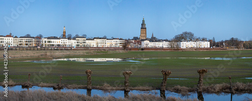 Panorama with floodplains in the foreground of the medieval Hanseatic renaissance city of Zutphen in The Netherlands with its several towers along the river IJssel photo