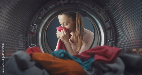 Woman smelling freshly washed laundry