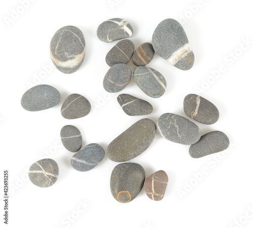 Grey pebbles isolated on white background. Grey sea stones with white stripes isolated on white. Studio shot.