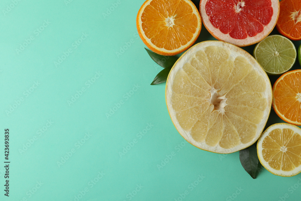 Ripe citrus on mint background, space for text Ripe citrus on mint background, space for text