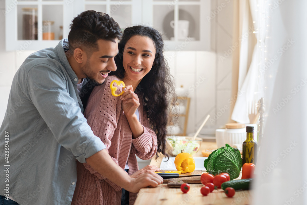 Cheerful Arab Couple Having Fun While Cooking Healthy Lunch Together In Kicthen Cheerful Arab Couple Having Fun While Cooking Healthy Lunch Together In Kicthen