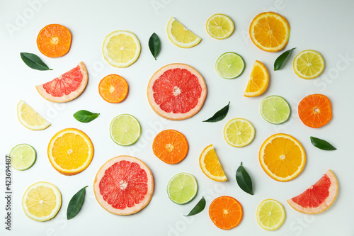 Flat lay with citrus slices on white background