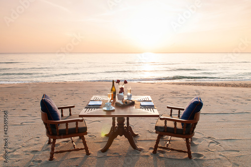 Romantic breakfast on beach. Breakfast table with island sunrise