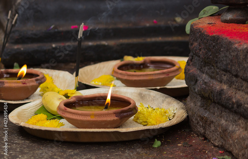 A beautiful picture of an Oil lamp made in clay kept in a Hindu temple for worship by the devotees in Karnataka,India. photo