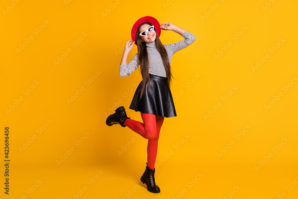 Full length body size view of charming trendy cheerful girl posing jumping having fun isolated on bright yellow color background Full length body size view of charming trendy cheerful girl posing jumping having fun isolated on bright yellow color background
