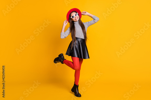 Full length body size view of charming trendy cheerful girl posing jumping having fun isolated on bright yellow color background