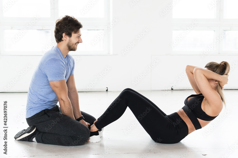 Fitness man and woman during workout with in the gym