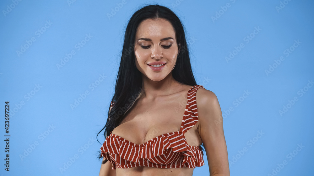 sensual, brunette woman in swimsuit posing isolated on blue sensual, brunette woman in swimsuit posing isolated on blue