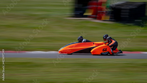 Photography A panning shot of a racing sidecar as it corners on a track.