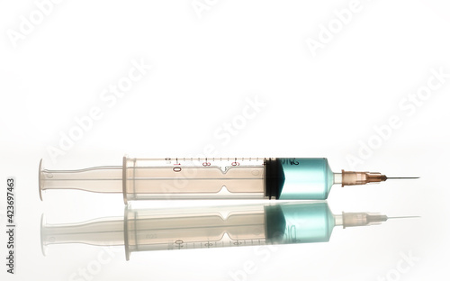 Fotografie A syringe with a blue liquid, a photo on the topic of medicine and the prolongation of youth