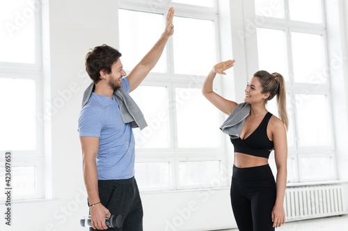 High five between man and woman in the gym after fitness workout © blackday
