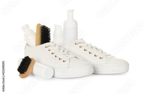 Composition with stylish footwear and shoe care accessories on white background