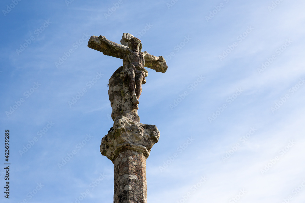 Antique carved stone cross called Cruceiro. Galicia, Spain. Low angle. Copy space