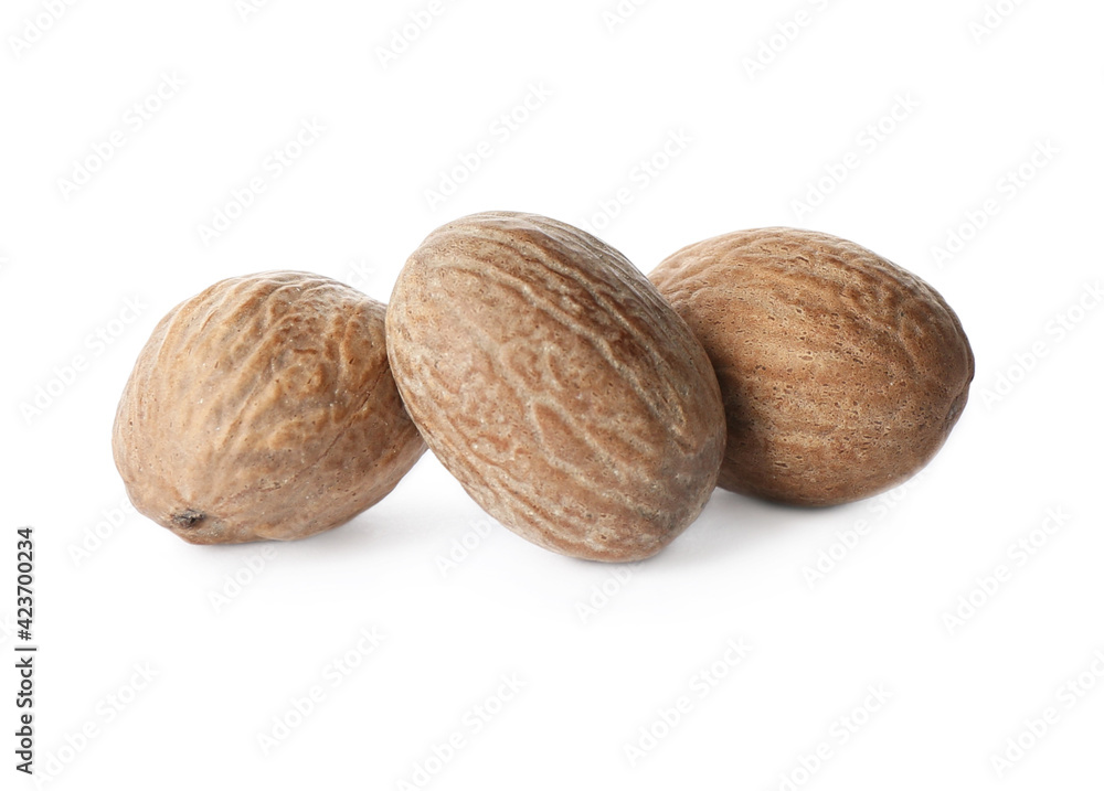 Three whole nutmeg seeds isolated on white Three whole nutmeg seeds isolated on white