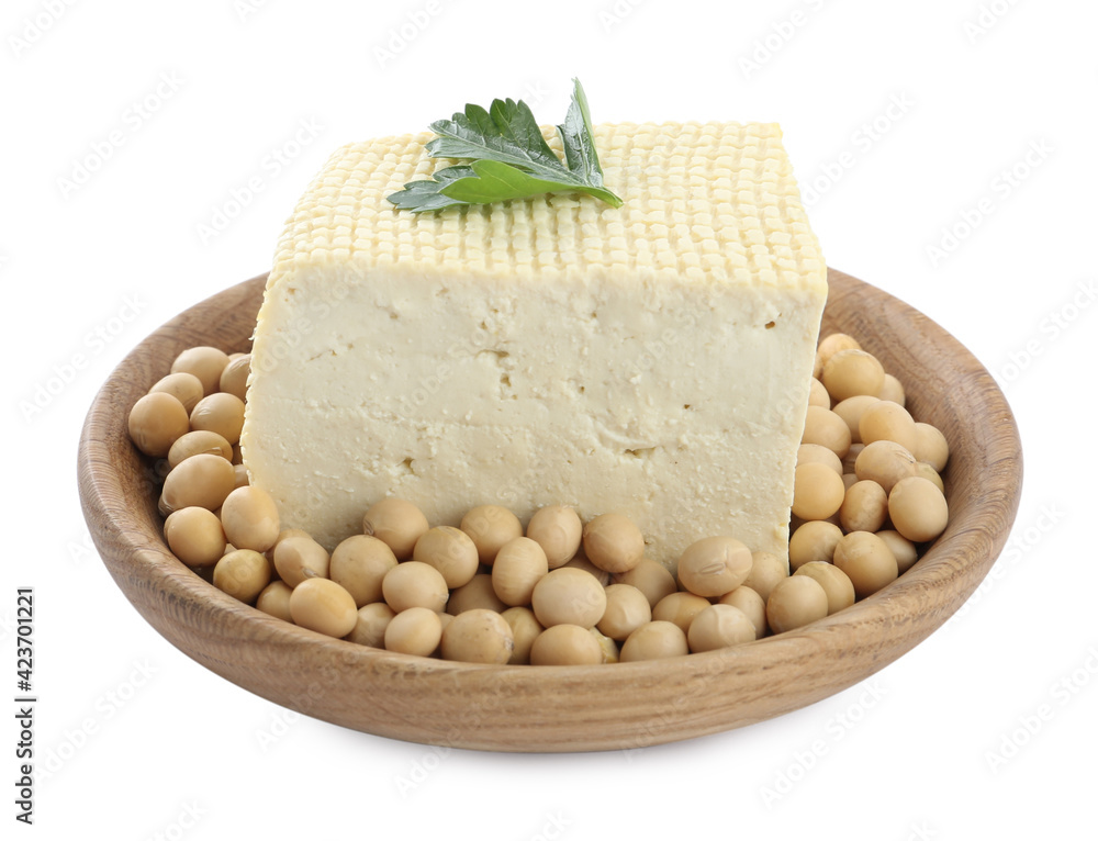 Piece of delicious tofu with parsley and soy on white background