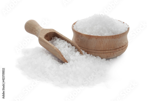 Natural salt in bowl and scoop on white background