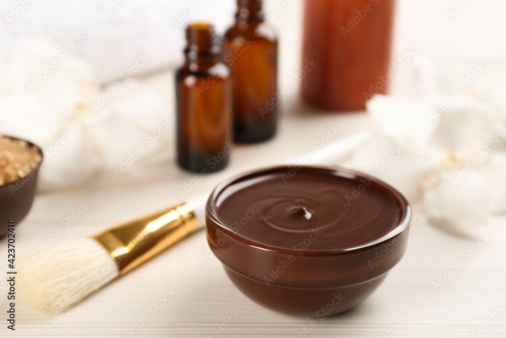 Composition with cosmetic product for spa body wraps on white wooden background Composition with cosmetic product for spa body wraps on white wooden background