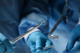 Professional surgeons with forceps and suture thread, closeup. Medical equipment
