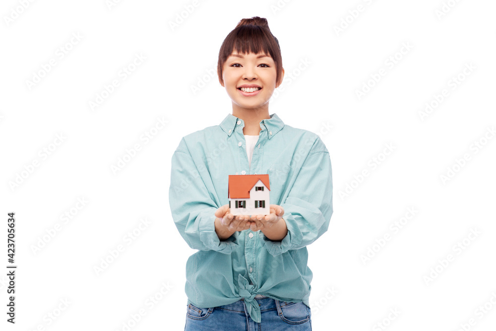mortgage, real estate and accommodation concept - happy smiling asian woman holding house model over white background mortgage, real estate and accommodation concept - happy smiling asian woman holding house model over white background