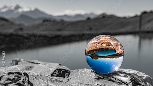 Crystal ball alpine landscape shot with black and white background outside the sphere at the famous Asitz summit, Leogang, Salzburg, Austria © Martin Erdniss