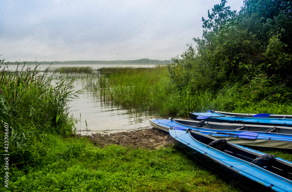a three kayaks on the beach of Peremut lake of Shatskyi Lakes group, Shatsk National Natural Park, Volyn region of Western Ukraine