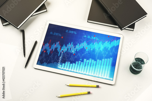 Modern digital tablet screen with abstract financial diagram, banking and accounting concept. Top view. 3D Rendering