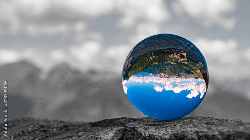 Crystal ball alpine landscape shot with black and white background outside the sphere at the famous Timmelsjoch high alpine road, Dolomites, South Tyrol, Italy Crystal ball alpine landscape shot with black and white background outside the sphere at the famous Timmelsjoch high alpine road, Dolomites, South Tyrol, Italy