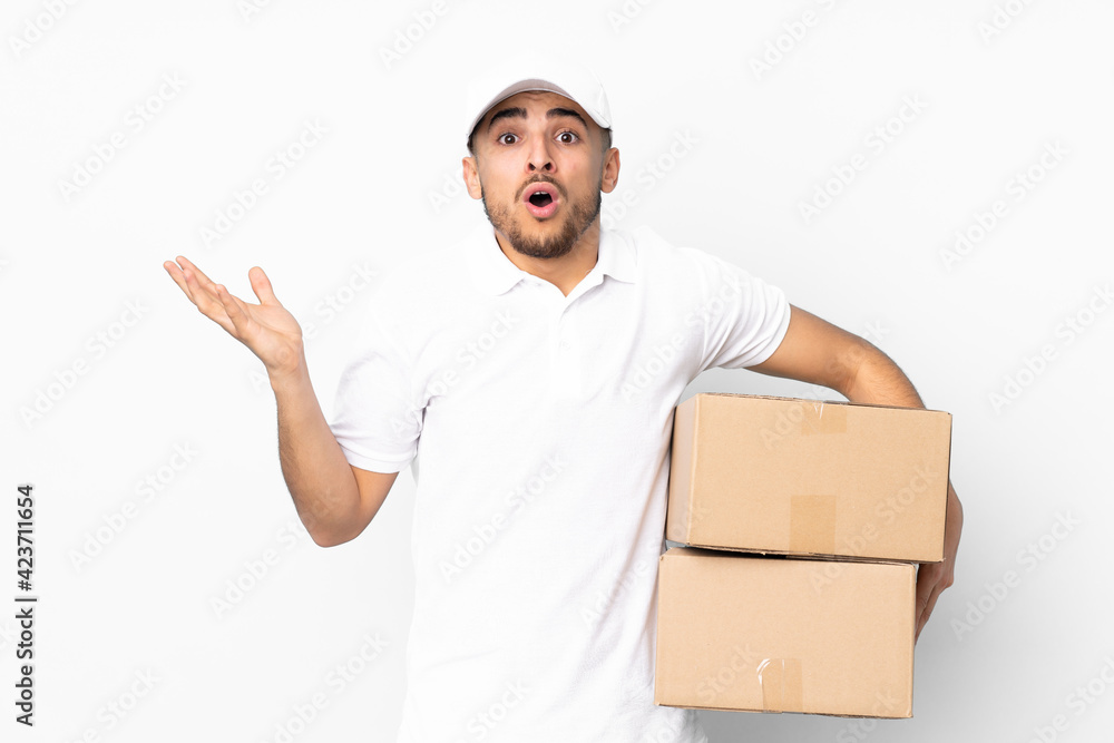 Delivery Arabian man isolated on blue background with surprise facial expression Delivery Arabian man isolated on blue background with surprise facial expression