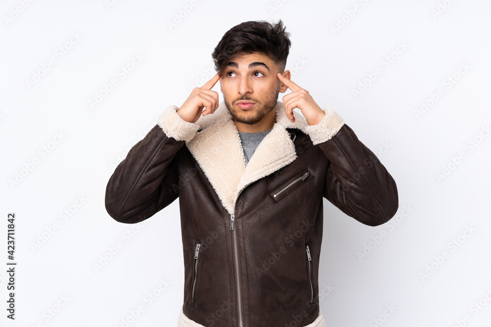 Arabian handsome man over isolated background having doubts and thinking Arabian handsome man over isolated background having doubts and thinking