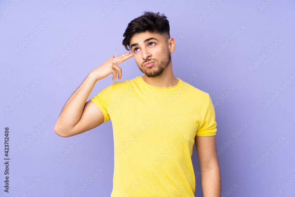 Arabian handsome man over isolated background with problems making suicide gesture Arabian handsome man over isolated background with problems making suicide gesture