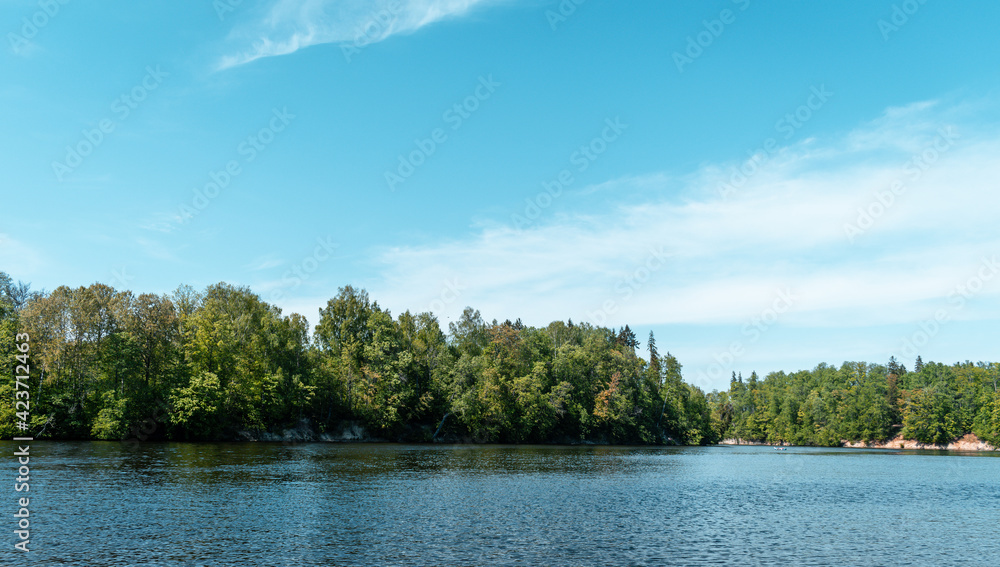 Koknese nature park from the shore of Koknese medieval castle ruins by the river Daugava. Beautiful green forest during sunny day Koknese nature park from the shore of Koknese medieval castle ruins by the river Daugava. Beautiful green forest during sunny day