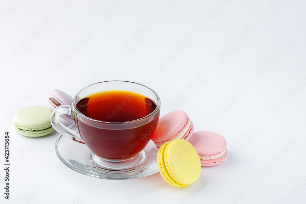 Cup of tea and colorful macaroons on a white background. Cup of tea and colorful macaroons on a white background.