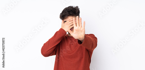 Arabian handsome man over isolated background making stop gesture and covering face