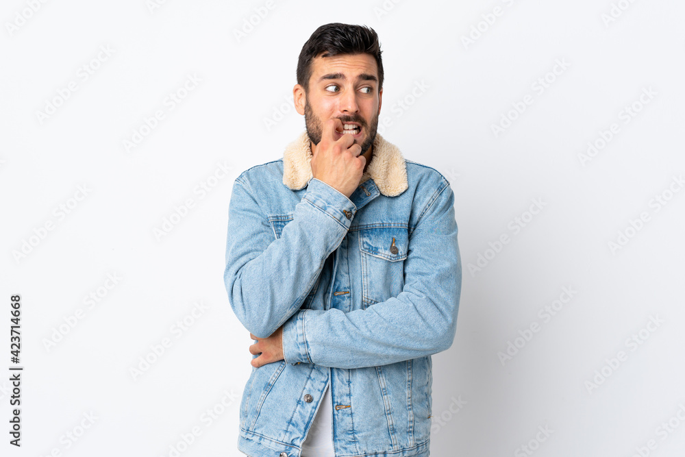 Young handsome man with beard isolated on white background nervous and scared Young handsome man with beard isolated on white background nervous and scared
