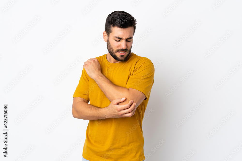 Young handsome man with beard isolated on white background with pain in elbow Young handsome man with beard isolated on white background with pain in elbow