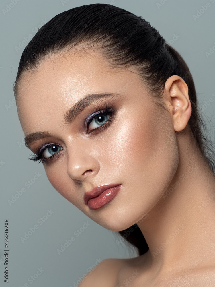 Naklejka premium Portrait of young woman with beautiful makeup